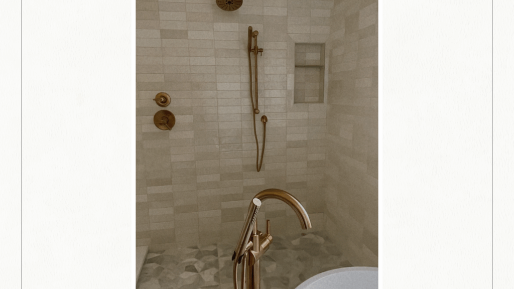 Beautiful tiled shower with zellige horizontal cream tiles on the wall and a fun floral pattern on the floor.